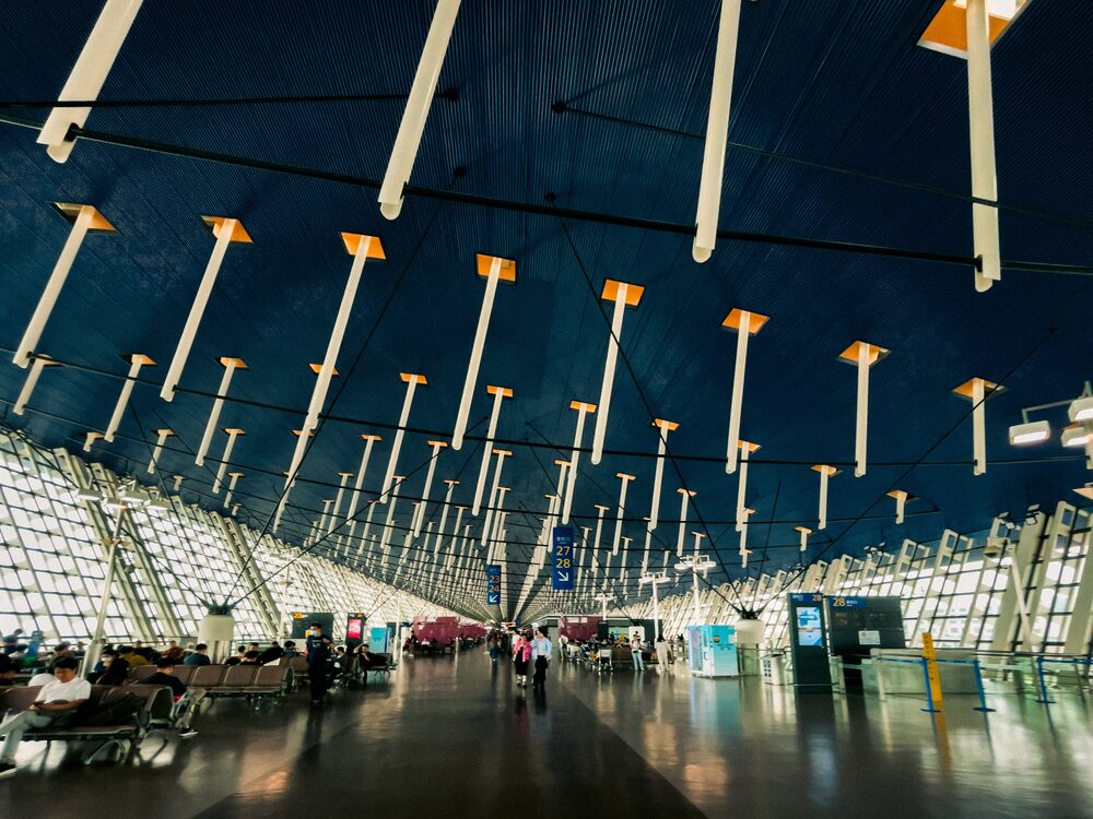 Departures hall of Terminal 1 at Shanghai Pudong International Airport with its high blue ceiling